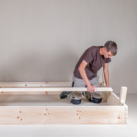 Mitarbeiter der Tischlerei Weissteiner beim Zusammenstellen des Gerüstes eines Holzbettes