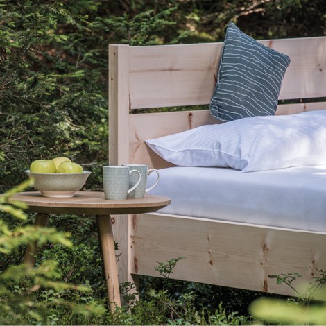 Stabiles Holzbett mit Rückenlehne und runder Nachttisch aus Holz